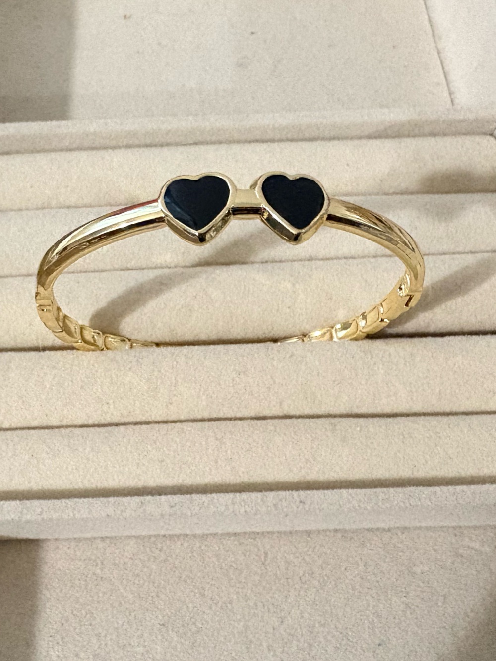 Gold Tone Bangle Bracelet with Black Heart Accents